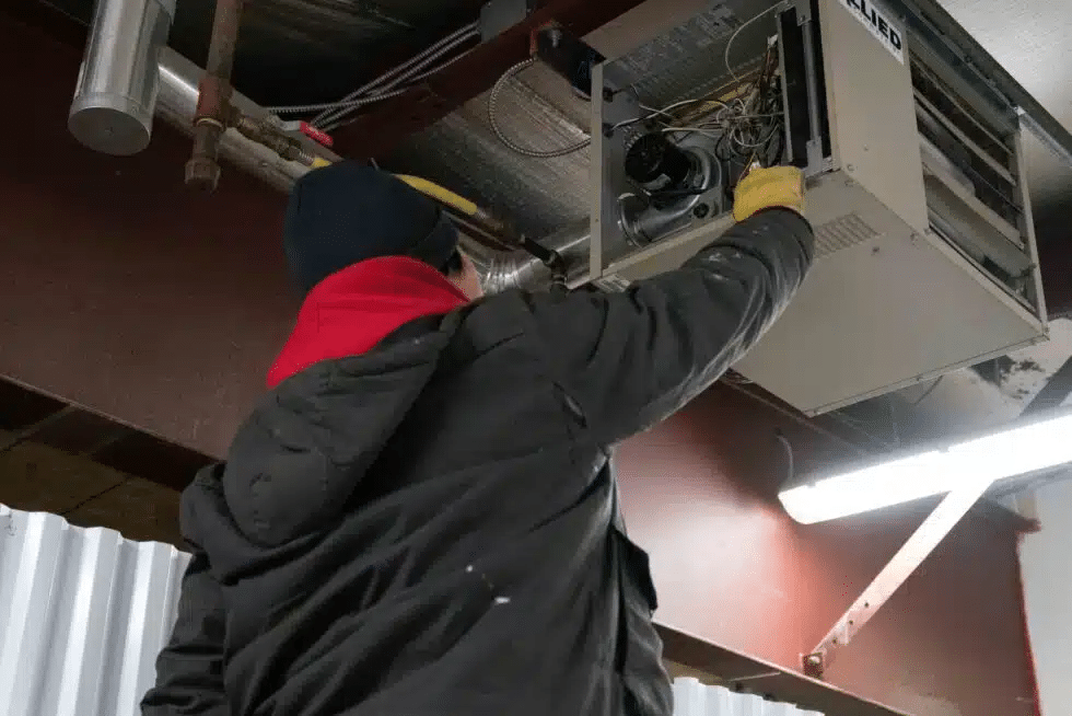 One of our experts installing a commercial garage heater in Saskatoon, Canada